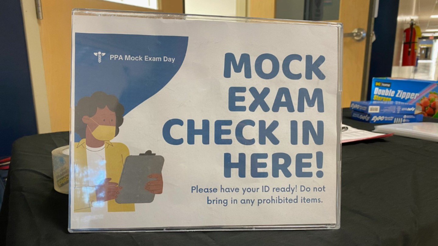 a check in sign for a mock exam